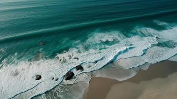 Airborne see of sandy shoreline with waves and clear ocean water. photo