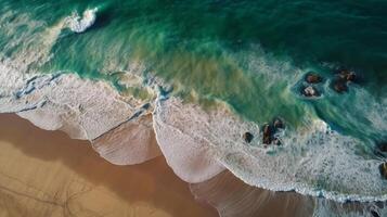 Airborne see of sandy shoreline with waves and clear ocean water. photo