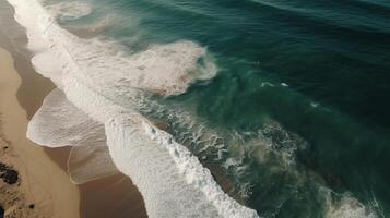 Airborne see of sandy shoreline with waves and clear ocean water. photo