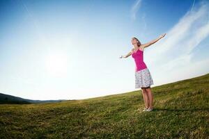 Woman with open arms outdoors photo