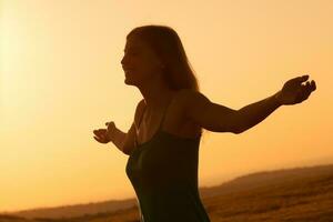 Woman with open arms outdoors photo