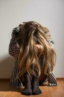 Depressed woman with her head down photo