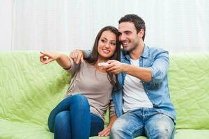 Couple watching TV on the couch photo