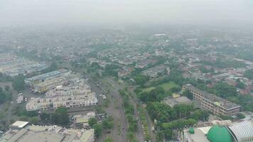 4K footage aerial view of the Kota Wisata highway when it's a bit foggy and overcast during the day. video