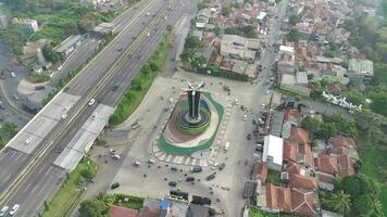 4k Aufnahmen Antenne Aussicht von Tugu pancakarsa im das Morgen beim das Kreuzung Seite durch Seite mit das Maut Straße. video