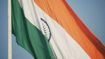 India flag flying high at Connaught Place with pride in blue sky, India flag fluttering, Indian Flag on Independence Day and Republic Day of India, tilt up shot, Waving Indian flag, Har Ghar Tiranga video