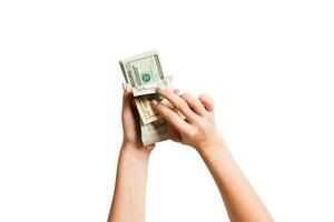 Top view of a bundle of money in female hands. Image of counting dollars on white isolated background. Tax concept photo