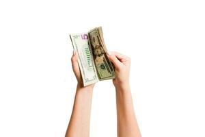 Isolated image of female hands counting dollars on white background. Top view of salary and wages concept photo