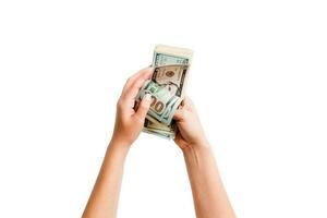 Isolated image of female hands counting dollars on white background. Top view of salary and wages concept photo