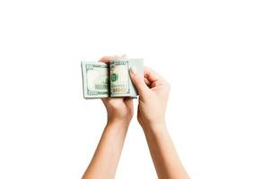 Top view of female hands counting dollar banknotes on white isolated background. Investment and prosperity concept photo