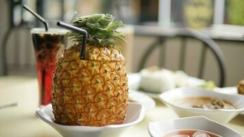 Pineapple juice with ice in a glass on the table photo