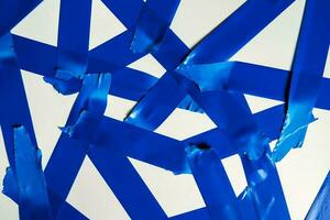 Torn blue sticky tape of different sizes isolated on a white background photo