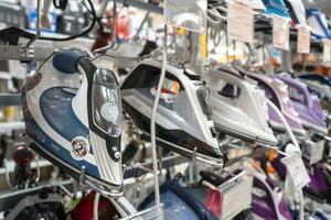 sale of irons in a home appliance store, various irons photo