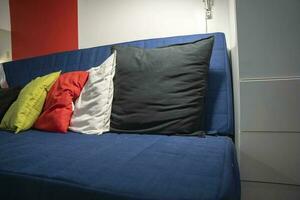 Colored pillows on a blue sofa, Living room furniture photo