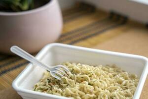 Chinese noodles with a bag of dried vegetables. close-up. Instant noodles photo