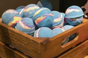 Colorful beautiful handmade Aromatic bath Bombs in a Wooden box photo