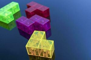 three-dimensional colored tetris figures on glossy black glass, space for copying photo