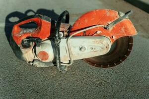 a gasoline cutting machine with a disc for cutting concrete photo