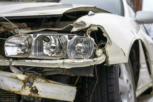 damaged emergency car headlight, hood and bumper photo