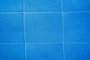 blue fabric backgroundbackground of blue fabric with stitching photo