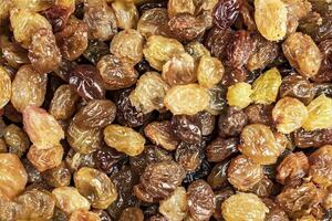 background of delicious sweet yellow raisins on the table close-up photo