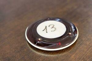 Wireless queue calling system. a pager for a restaurant with number 13 photo