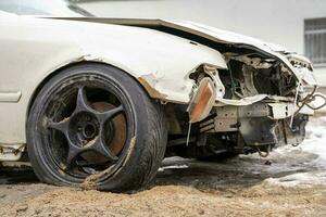 white smashed sedan with black wheels photo