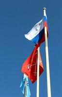 Flag of Saint Petersburg city with Russian Federation flag on Palace Bridge over the Neva river - Saint Petersburg, Russia photo