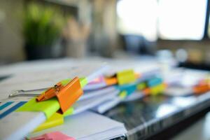 Businesswoman hands working on stacks of paper documents to search and review documents piled on table before sending them to board of directors to use  correct documents in meeting with Businessman photo