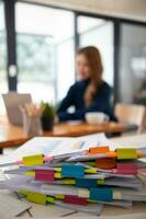 Businesswoman hands working on stacks of paper documents to search and review documents piled on table before sending them to board of directors to use  correct documents in meeting with Businessman photo