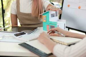 Engineers and designers are discussing the layout of the house and the construction schedule to be completed on schedule. House construction ideas with a team of professional engineers and designers. photo