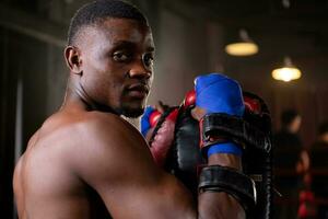 Portrait of boxer's training partner self-defense equipment must be used in order for the boxer to fully use the weapon against him. photo