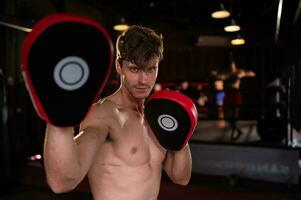 Portrait of boxer's training partner self-defense equipment must be used in order for the boxer to fully use the weapon against him. photo