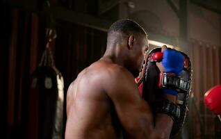 Portrait of boxer's training partner self-defense equipment must be used in order for the boxer to fully use the weapon against him. photo