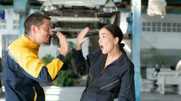Portrait of engineer and auto mechanic with working on engine repairs in car garages photo