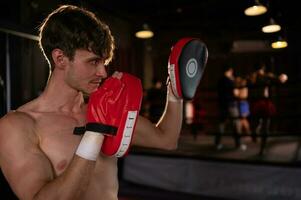 Portrait of boxer's training partner self-defense equipment must be used in order for the boxer to fully use the weapon against him. photo