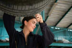 A mechanic for automobiles examining the condition of tires that have been in use for some time photo