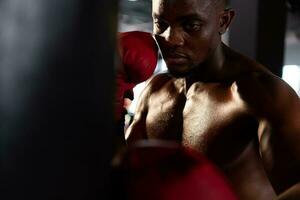 Portrait of boxers must practice their kicking and punching skills with punching bag. To build strength and power of kicking and punching. photo