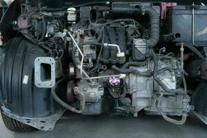 The engine of a car that has been hit hard. Professional technicians repair until it is in normal working condition. photo