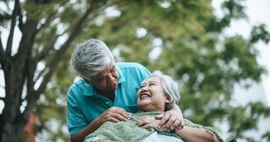 Mature asian couple relax with happy in park photo