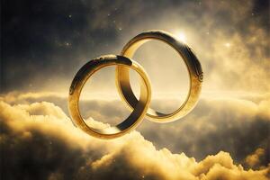 A pair of gold wedding rings floating in the sky. two wedding rings floating in the clouds with a sun in the background and a blue sky with clouds below them. . Wedding concept. photo