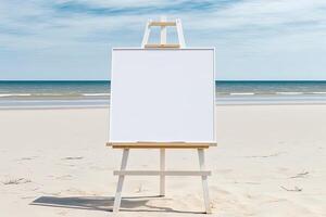 White blank artist frame on a small wooden easel on summer sea beach background with copy space. Advertising mockup artboard for pictures or artwork. Painting frame template banner. photo