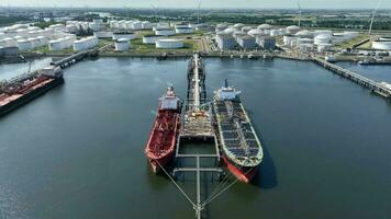 Crude Oil Tanker Ships Unloading Petrochemicals to a Shore Fuel Depot video