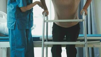 young asian physical therapist working with senior woman on walking with a walker video