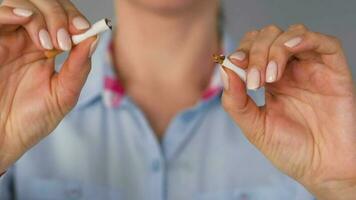 Quit smoking concept, woman cuts cigarettes with scissors. video