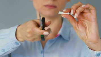 Quit smoking concept, woman cuts cigarettes with scissors. video