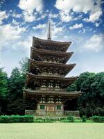 Closeup wooden Five Storied Pagoda in Daigoji Temple on bright blue sky background, Kyoto, Japan photo
