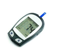 Glucose meter machine and numbers of glucose in the blood show on screen with sheet check isolate on white background and make with paths. photo