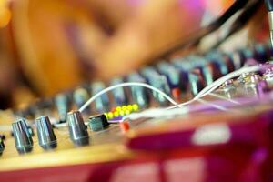 Closeup knobs and button of sound control in colorful lights party on blurry background. photo