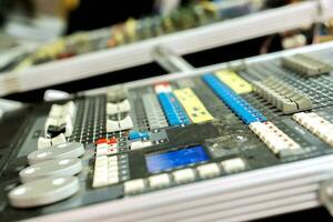 Closeup and crop of knobs with button of sound music mixer control panel on blurry background. photo